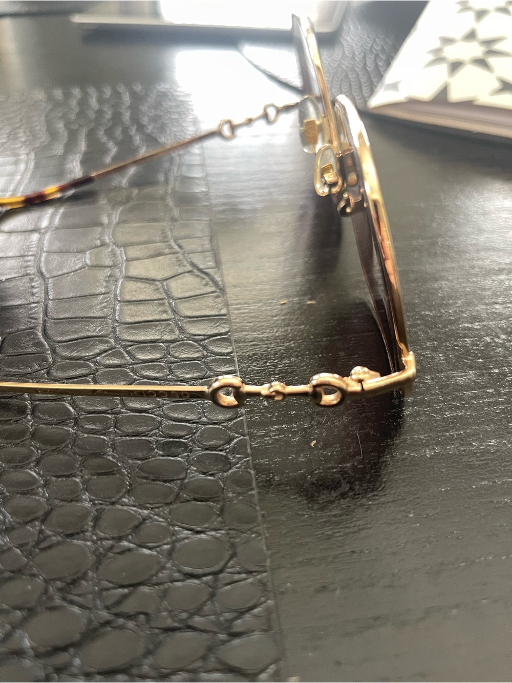 Gucci GG0879S Horsebit oversized sunglasses featuring a gold-tone metal frame